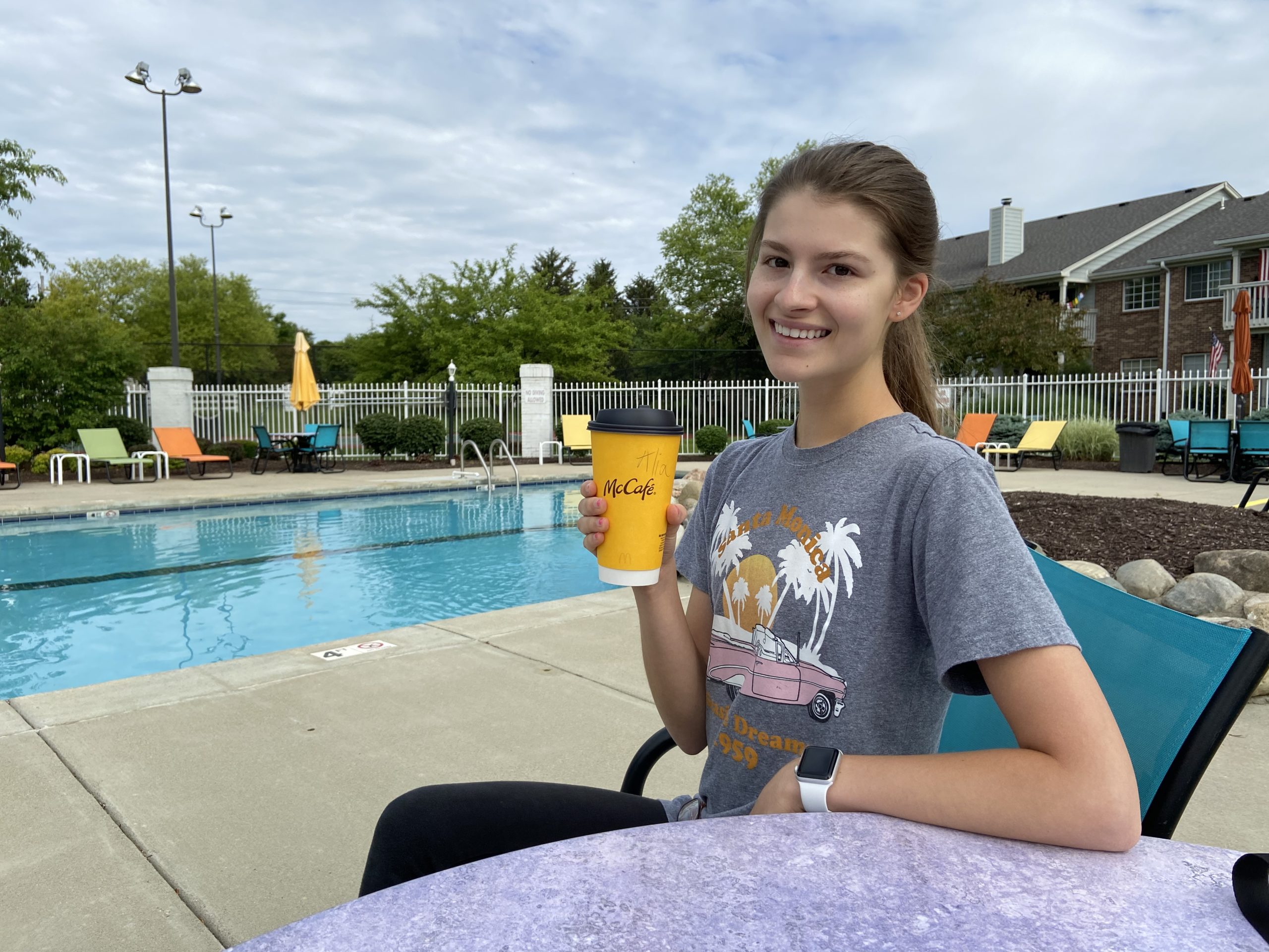 Alia at pool with coffee