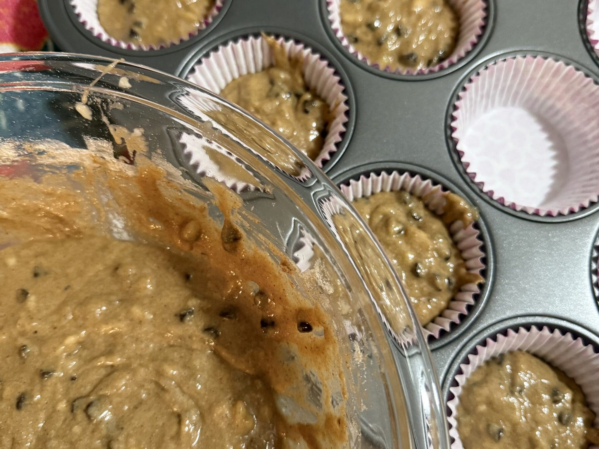 Chocolate chip muffin batter in muffin tin