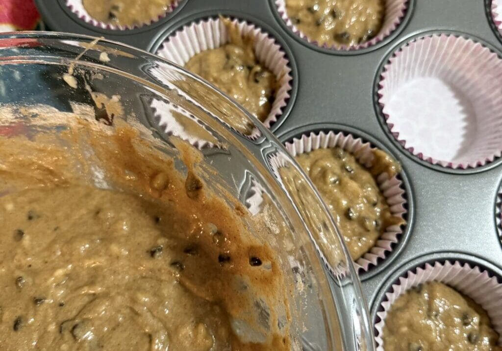 Chocolate chip muffin batter in muffin tin